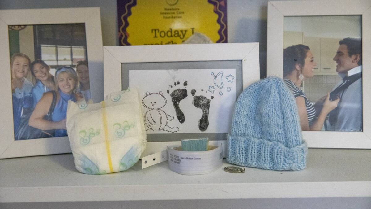 Darcy's tiny nappy, beanie and footprints from when he was born are displayed in the family home. Picture: Keegan Carroll