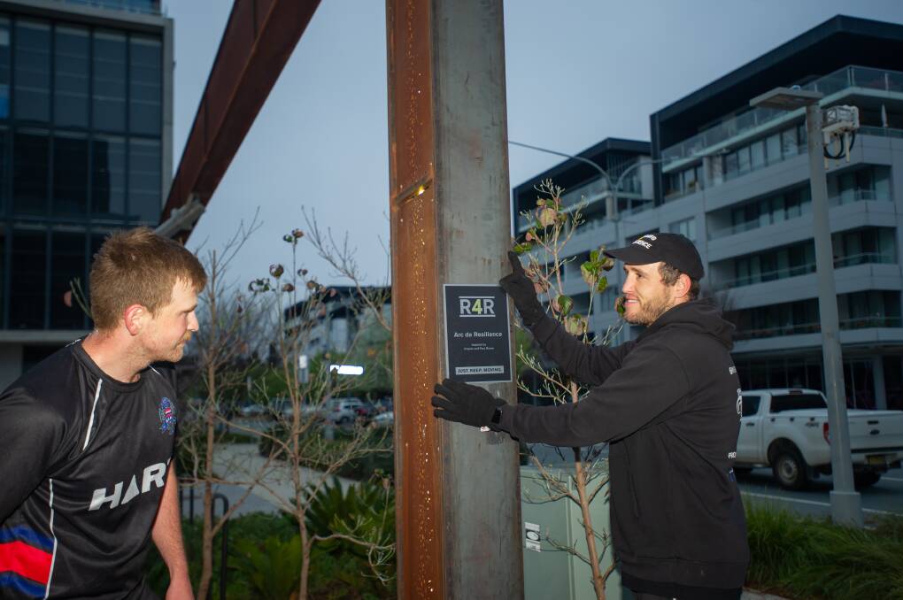 Matt Breen (left) with Ben Alexander on Thursday morning. Ben is showing Matt a mock-up of a plaque that will be placed on the newly-named Arc de Resilience. Picture: Karleen Minney
