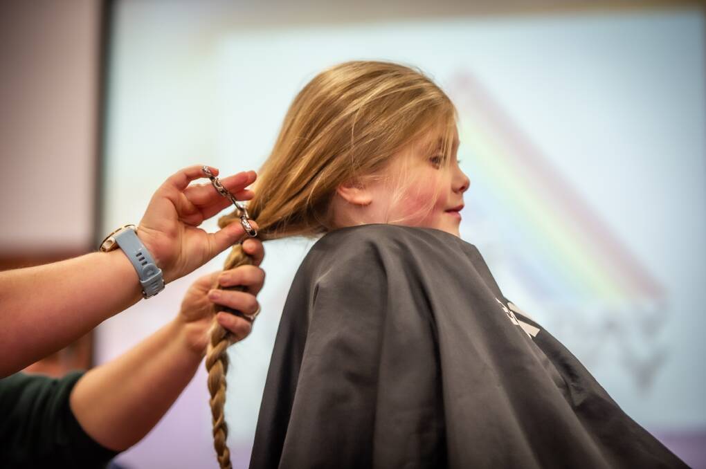 Hairdresser Ellie Darman from LaRuJa in Googong volunteered to cut Charlotte's hair. Picture: Karleen Minney