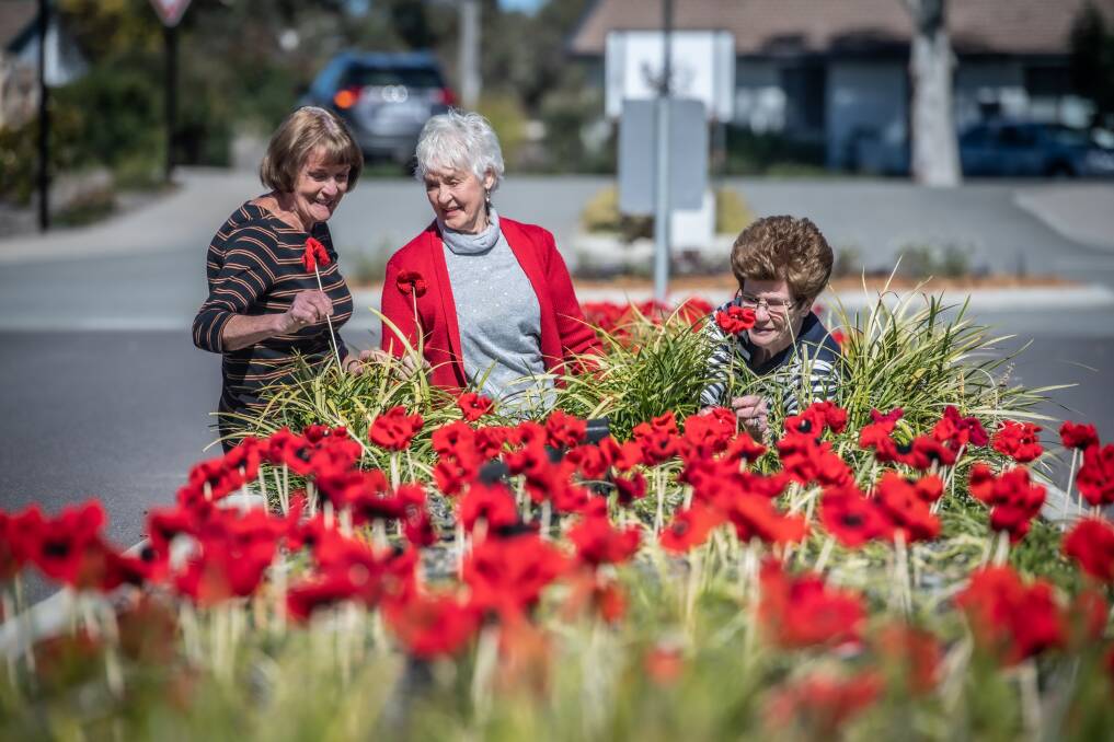 Joyce Rooney, Noreen Bird and Helen Crennan with the poppies in Kambah. Picture: Karleen Minney