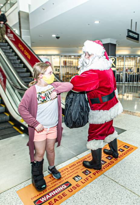 Makayla Essex, 9, of Oxley, greets Santa. Picture: Karleen Minney