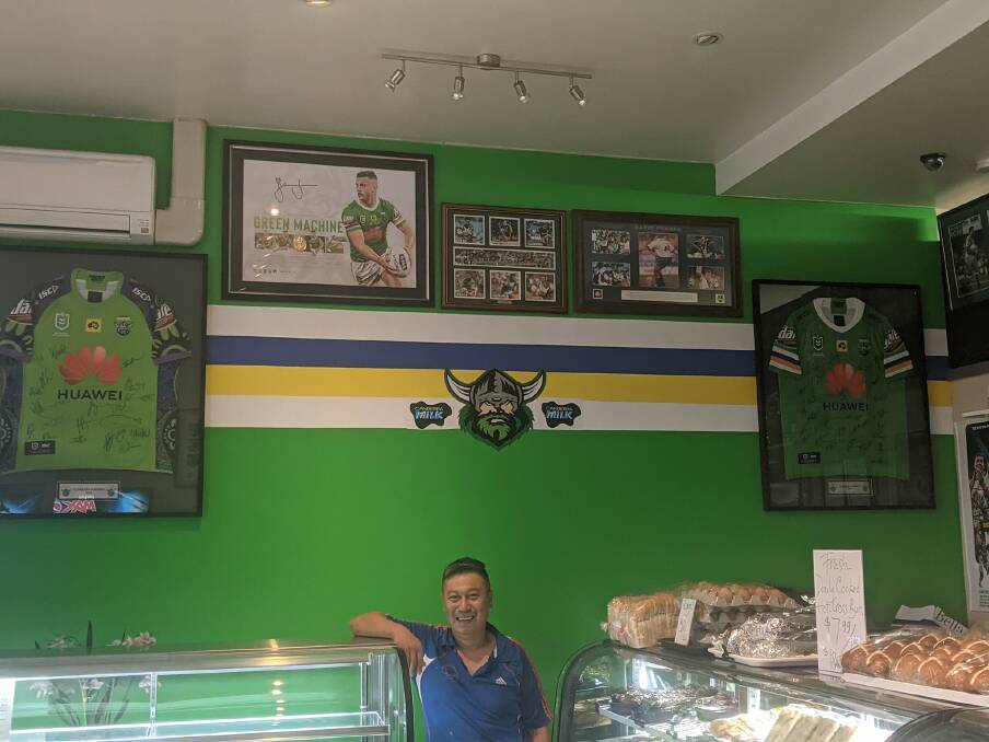 Quan Nguyen from the Vina Bakery and Coffee Shop with the tribute wall on Friday. Picture: Megan Doherty