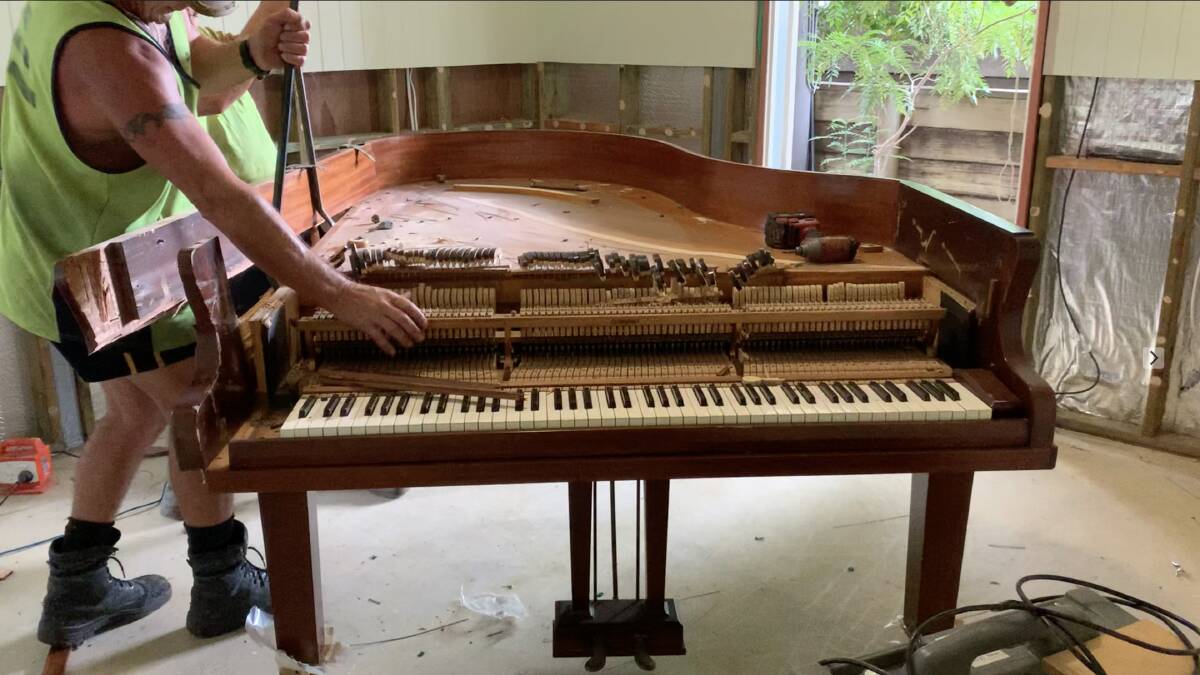 Eve's precious grand piano was demolished after being destroyed in a flood last year. Picture: Supplied