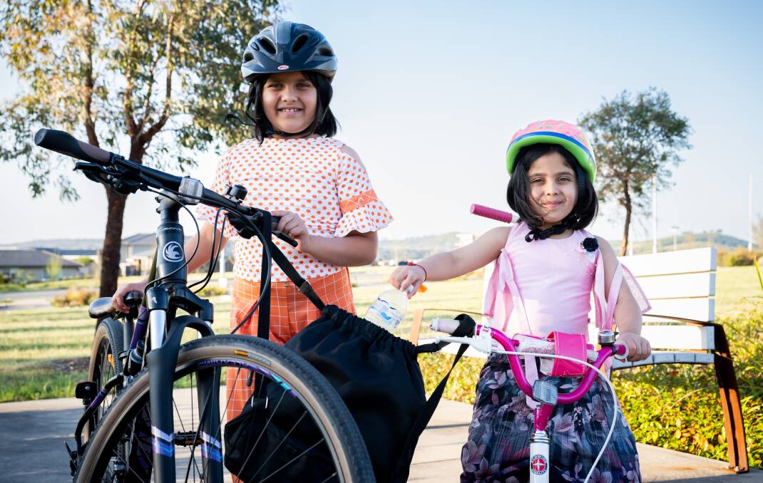Arushi and Avni ride their bikes around the neighbourhood looking for containers to recycle. Picture by Elesa Kurtz