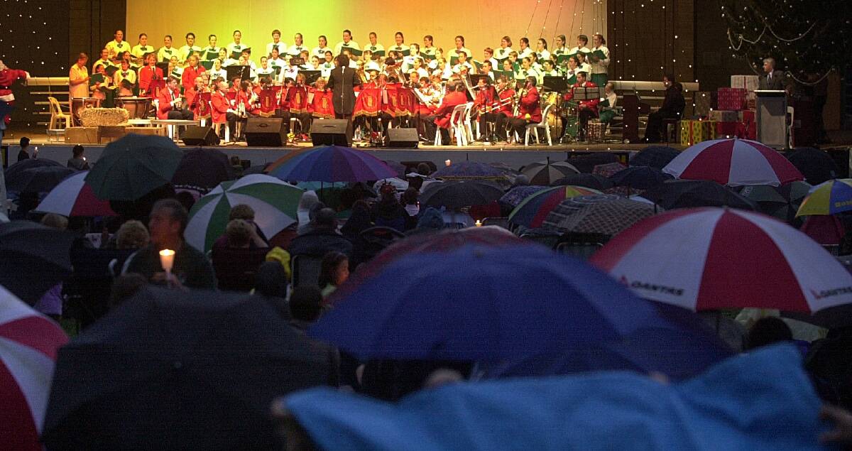 Even in the rain in 2012, crowds still flocked to the carols by candlelight at Stage 88. Picture by Gary Schafer