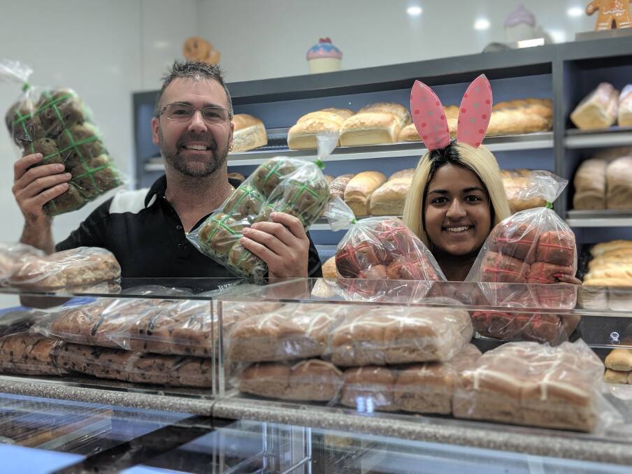 Erindale Cakery Bakery owners Clinton and Shubana Sheehan with their popular flavoured hot cross buns. Picture: Megan Doherty.