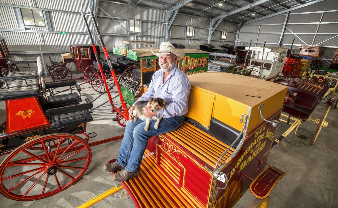 Paul Keir, with his best mate Bouncer the dog, with the collection of carriages. Picture by Sitthixay Ditthavong
