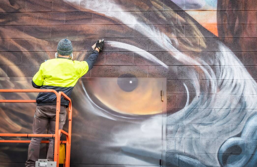 Geoff Filmer works on a detail of the Little Eagle, which is found in the Gungahlin area. Picture: Karleen Minney