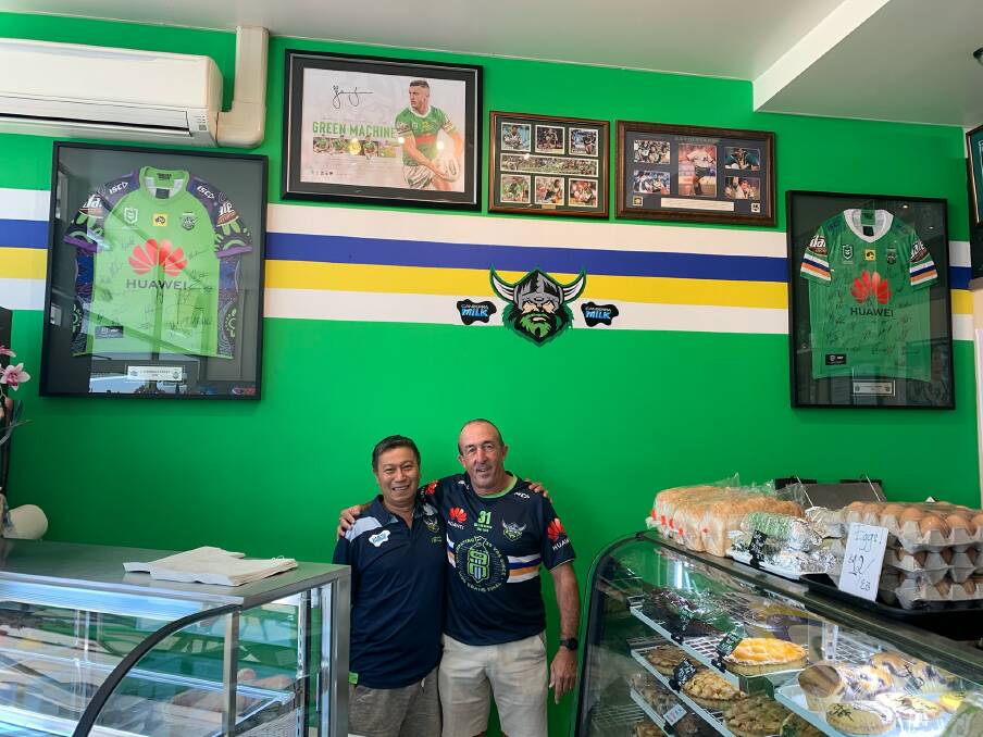 Wanniassa baker Quan Nguyen in front of his new Raiders wall with Green Machine legend Angel Marina. Picture: Supplied