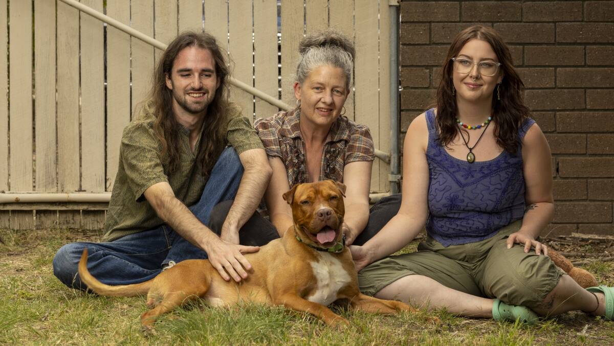 Kate Aspland, centre, is the new owner of Oberon (aka Obi). Obi is also sharing his new home in Belconnen with Kate's daughter Eve Aspland-Burns and Eve's boyfriend Dustin Copelin. Picture by Gary Ramage