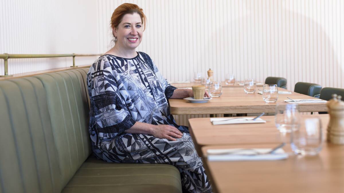 Tara Cheyne in a geometric dress by Canberra designer Karen Lee. She is pictured in the new Walter cafe at Regatta Point. Picture: Keegan Carroll