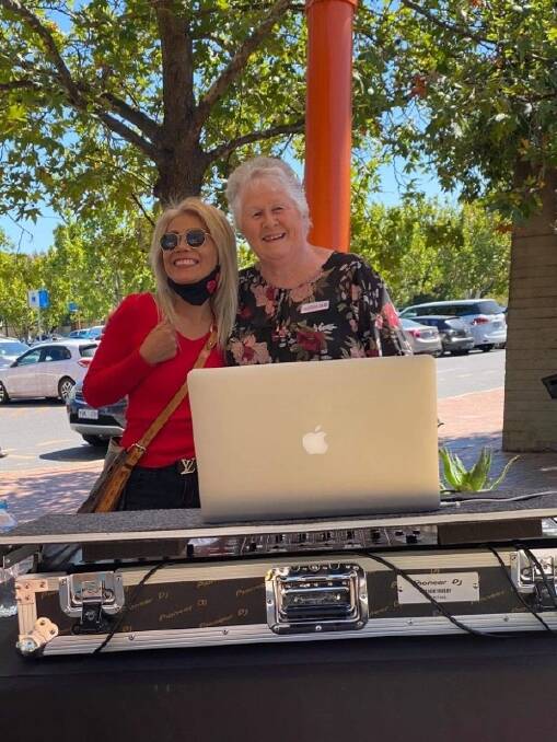 DJ Sue Freeman (right) at the Dickson shops with a fan. Picture: Supplied