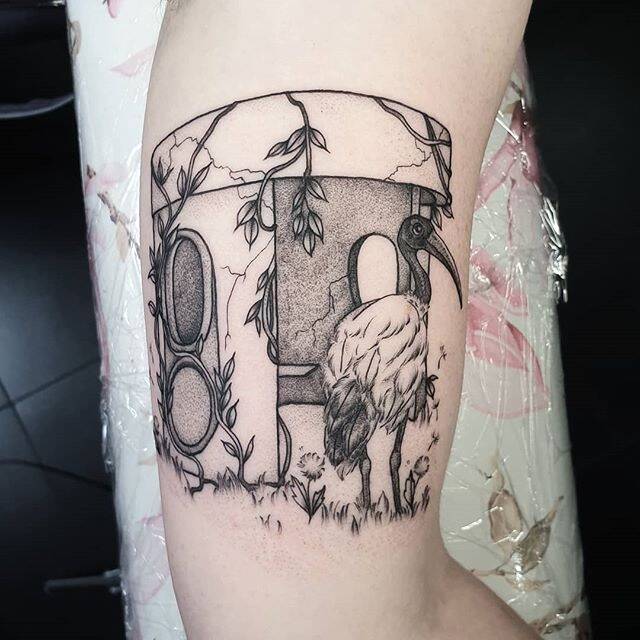 A Jessica Rebell tattoo of a bus shelter on Frankie McNair's arm.