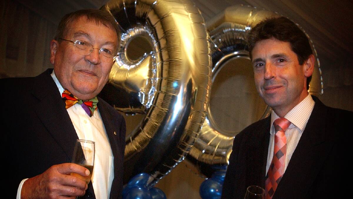 Mr Service, left, in 2005 when he was chairman of Actew celebrating its 90th birthdayu with Celebrating AGL managing director Greg Martin. Picture: Marina Neil