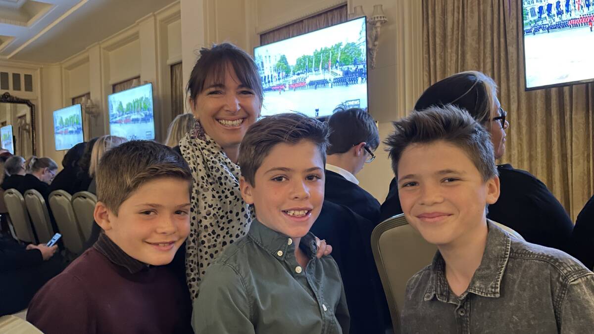 Lucie Collins and sons James, 9; Tobias, 11; and Oliver, 13, at Government House to watch the Queen's funeral. The family is on secondment to Canberra from England with husband and dad Charles, a commander in the Royal Navy. Picture by Megan Doherty