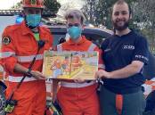Sutton SES members with a copy of the book Emergency!, Emergency! - Vehicles to the Rescue by Rhian Williams. Picture: Rhian Williams