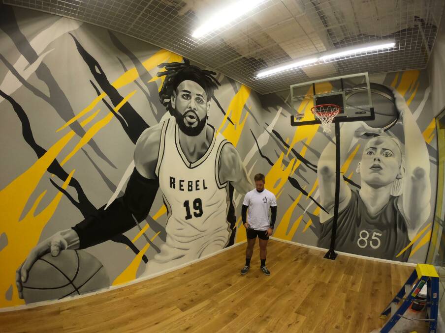 Artist Smalls with his new mural.