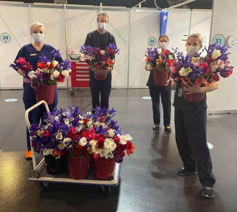 Workers at the AIS vaccination hub receive the blooms. Picture: Supplied