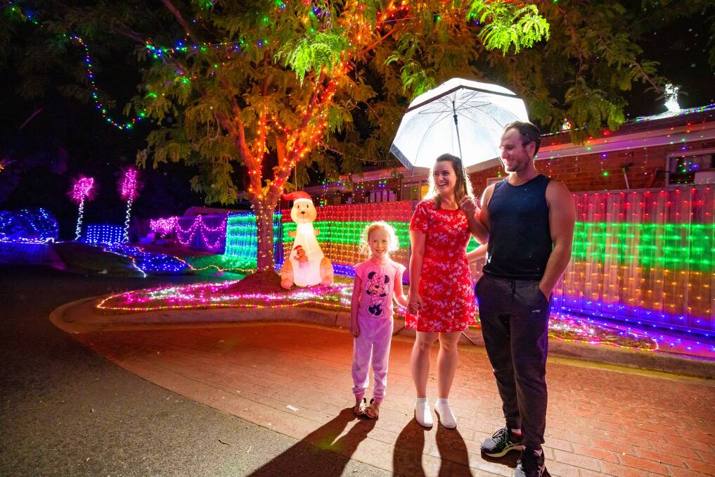 Harper, Morgan, and Jared were drawn to the Christmas lights in Burraly Court, Ngunnawal on Wednesday night. Picture: Sitthixay Ditthavong