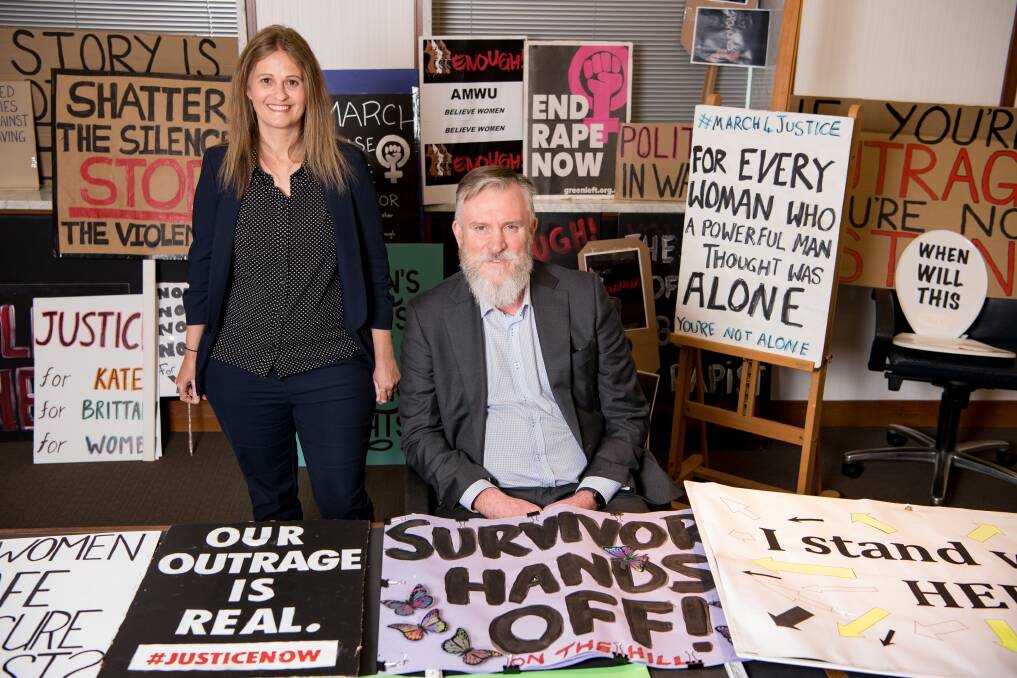 The National Library's Dr Shirleene Robinson, director of curatorial and collection research, and Kevin Bradley, assistant director-general responsible for collections, with some of the March 4 Justice signs. Picture: Jacque Gutterson