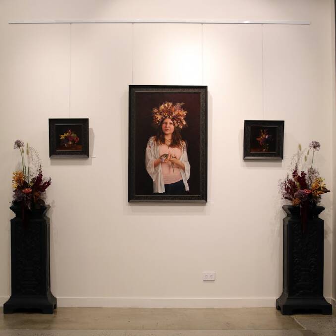 Narelle Zeller's work on display at the Grainger Gallery with blooms by Canberra floral artist Amy Clement. Picture: Supplied