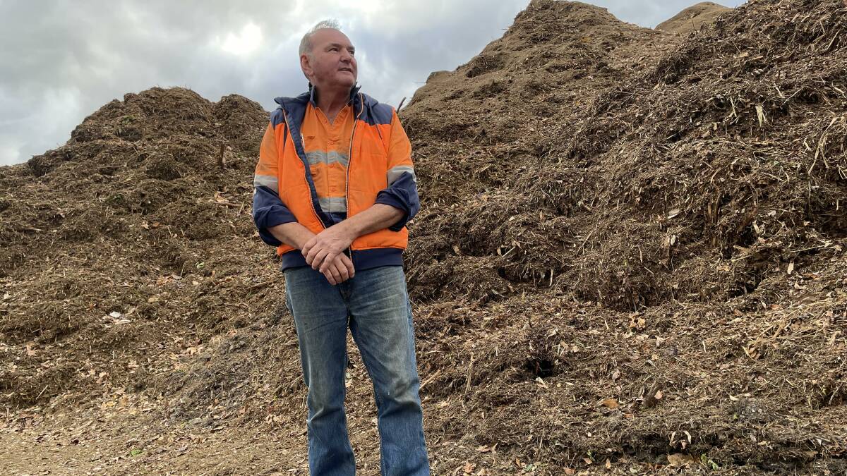 Corkill Bros director Phillip Corkhill with a mound of garden waste at the Mugga Lane tip on Friday. Picture: Megan Doherty