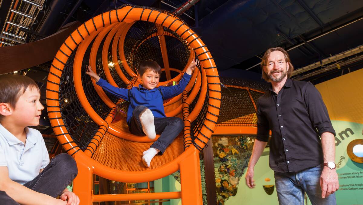 National Museum of Australia curator Jono Lineen, right, with David, 6, and Edward, 4, Siu in the new Tim and Gina Fairfax Discovery Centre. Picture by Sitthixay Ditthavong