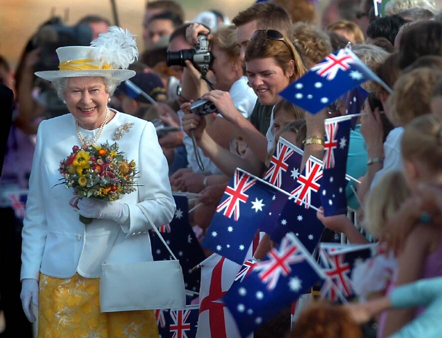 The Queen greets the crowd at Fairbairn as she arrives for her 2006 tour. Picture by Melissa Adams