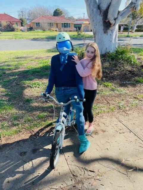 Charis Bateman, 10, of Watson, with the second-placed scarecrow, COVID Blues. Picture: Supplied