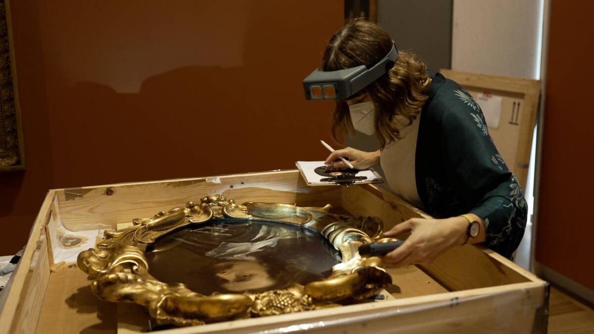 Stephanie Carlton inspects a piece before it is hung. Picture: Mark Mohell