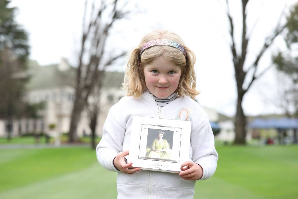 Six-year-old Elizabeth Paynter, of Curtin, brought a framed picture of her namesake to Government House on Friday. Picture by James Croucher