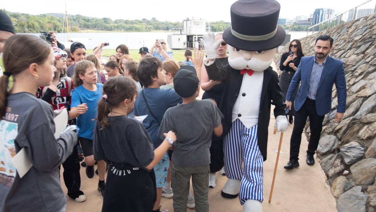 Mr Monopoly was swarmed by school children on a visit to the National Museum in Canberra. Picture by Karleen Minney 