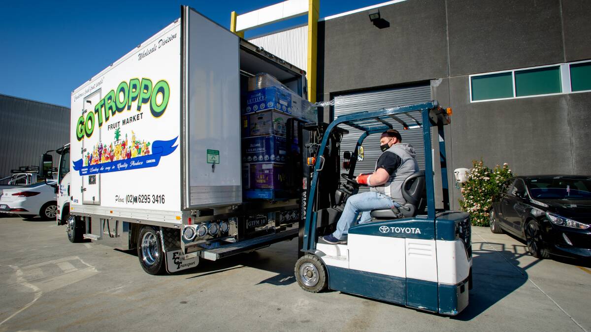 Go Troppos Marcus Commisso loads a truck with food donations. Picture: Elesa Kurtz.