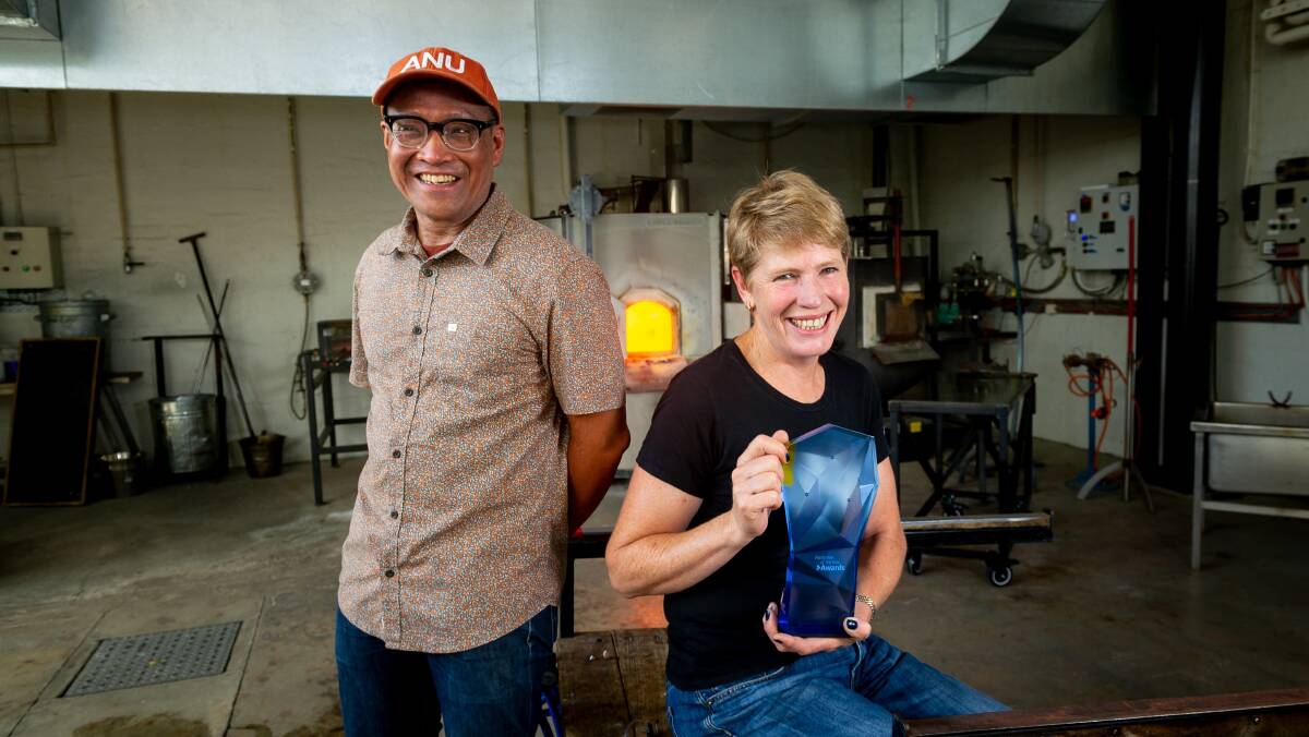  ANU Glass Workshop head Dr Jeffrey Sarmiento and production manager Catherine Newton with the trophy. Picture by Elesa Kurtz