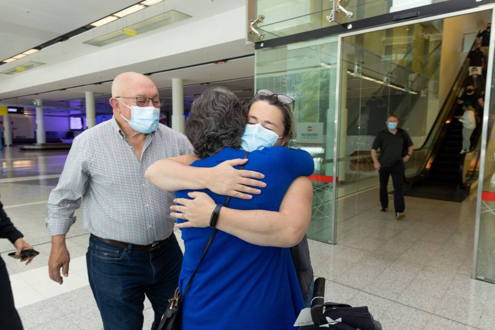 Claire Meeks greets her parents Colette and John Mackay at Canberra airport on Monday. Picture: Sitthixay Ditthavong