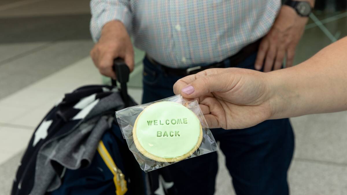 Passengers touching down in Canberra on Monday were handed little Welcome Back biscuits. Picture: Sitthixay Ditthavong