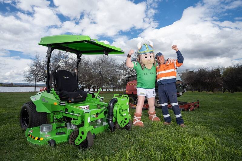 Victor the Viking with the new electric ride-on mower and Victor the mower operator. Picture supplied