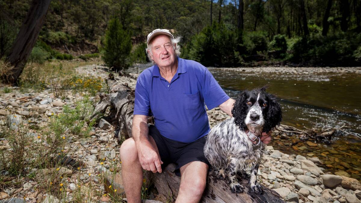 Wayne West, with his dog Sandy, said wildlife along the Goodradigbee River in the Brindabellas had still not returned to what it was before the 2003 firestorm. Picture by Sitthixay Ditthavong