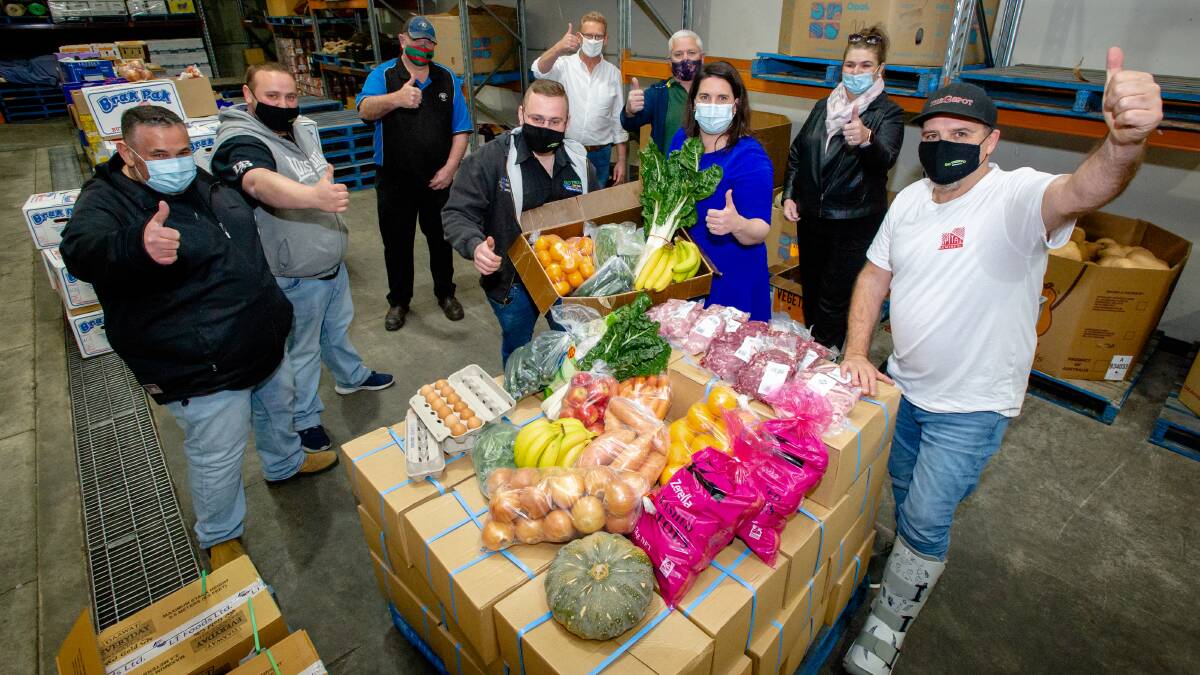 Go Troppo's Frank, Marcus and Joel Commisso, Brett Palmer of Long Park Meat Co, Liberal MLAs Mark Parton and Giulia Jones, Picking up the Peace's David and Kate Tonacia and The G Spot's Andrew Dale at Go Troppo's warehouse in Fyshwick on Wednesday. Picture: Elesa Kurtz
