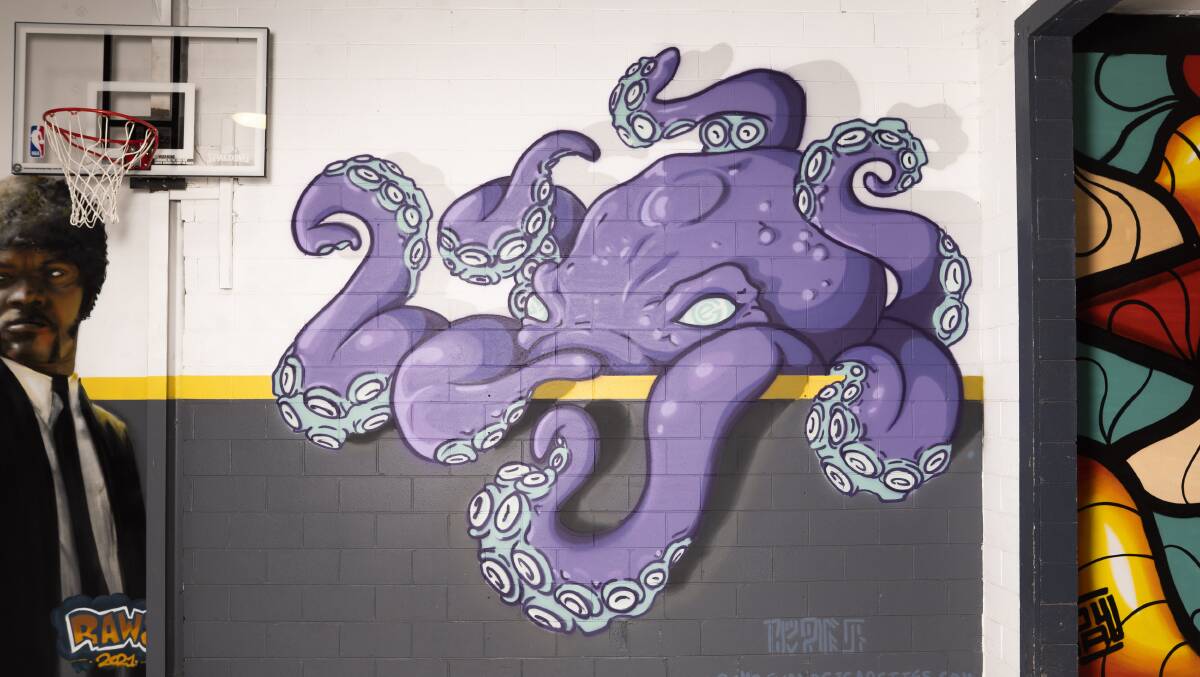 Artist Lachie Taylor did the purple octopus in the workshop. Picture: Dion Georgopoulos
