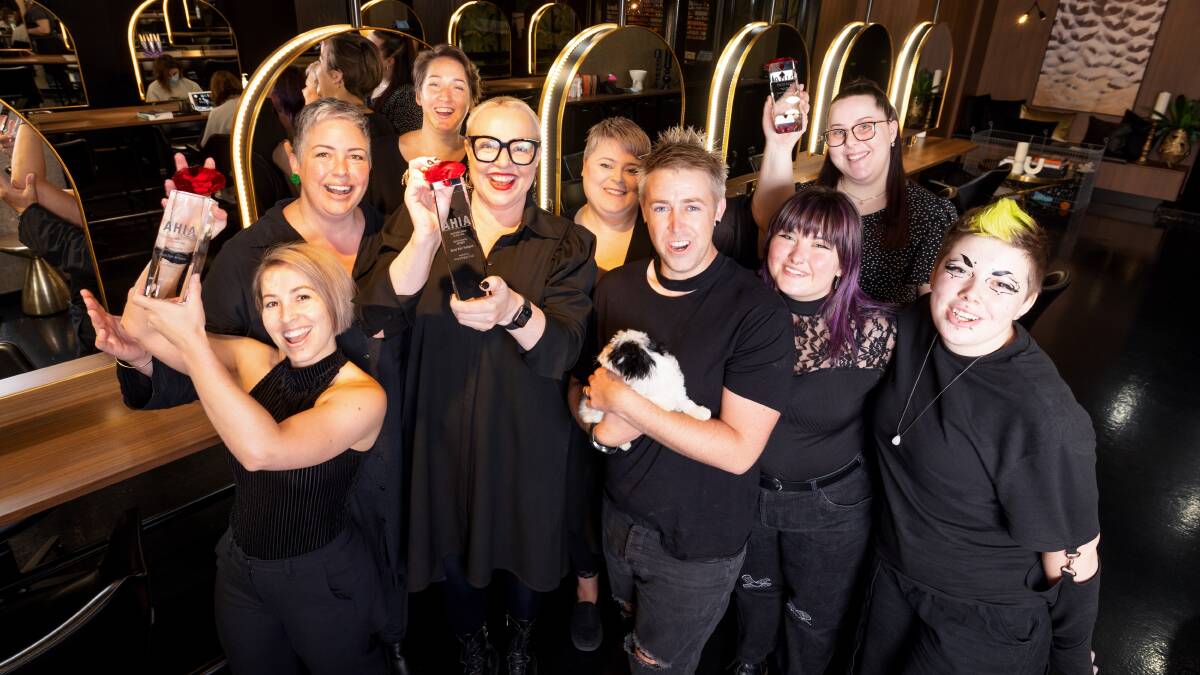 The team at Bond Hair Religion, including owner Jenni Tarrant (centre) and salon dog Bob, celebrate the win. Picture: Sitthixay Ditthavong