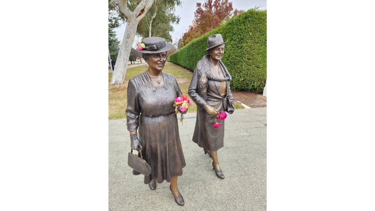 The statues of Dame Dorothy Tangney and Dame Enid Lyons adorned with flowers. Picture by Cormac Farrell