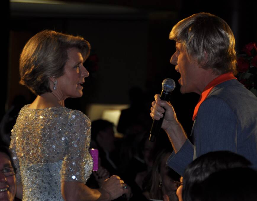 Julie Bishop at the 2013 Midwinter Ball with MC Bob Downe. Picture: Lyn Mills