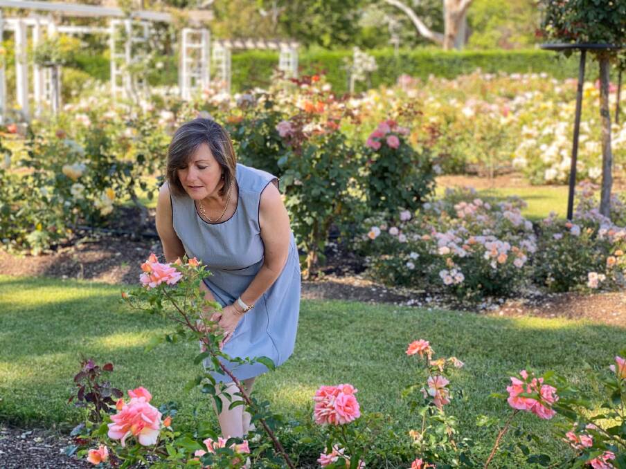 National Capital Authority's manager of open space Michelle Jeffrey stops to smell the roses. Picture: Ilona Fraser