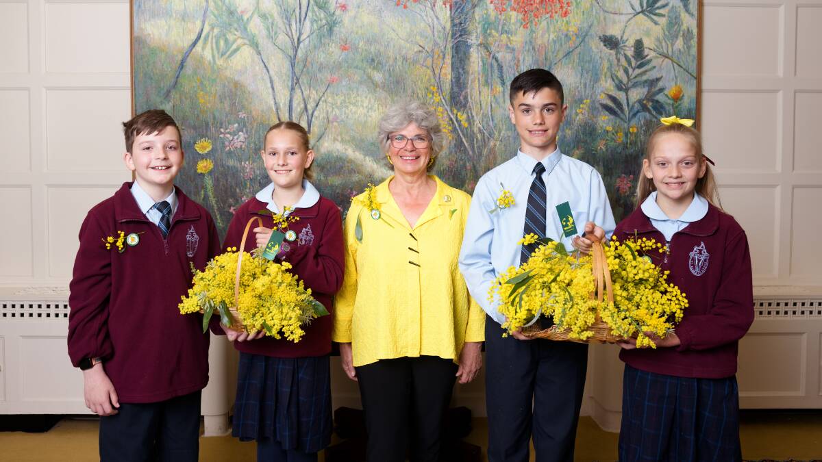 Wattle Day Association president Dr Suzette Searle at Government House on Thursday with students from St Clare of Assisi Primary School (l-r) Lucius Maybanks, Daisy Blenkin, Lincoln Barrett and Lilly Tunningley. Picture by Sitthixay Ditthavong