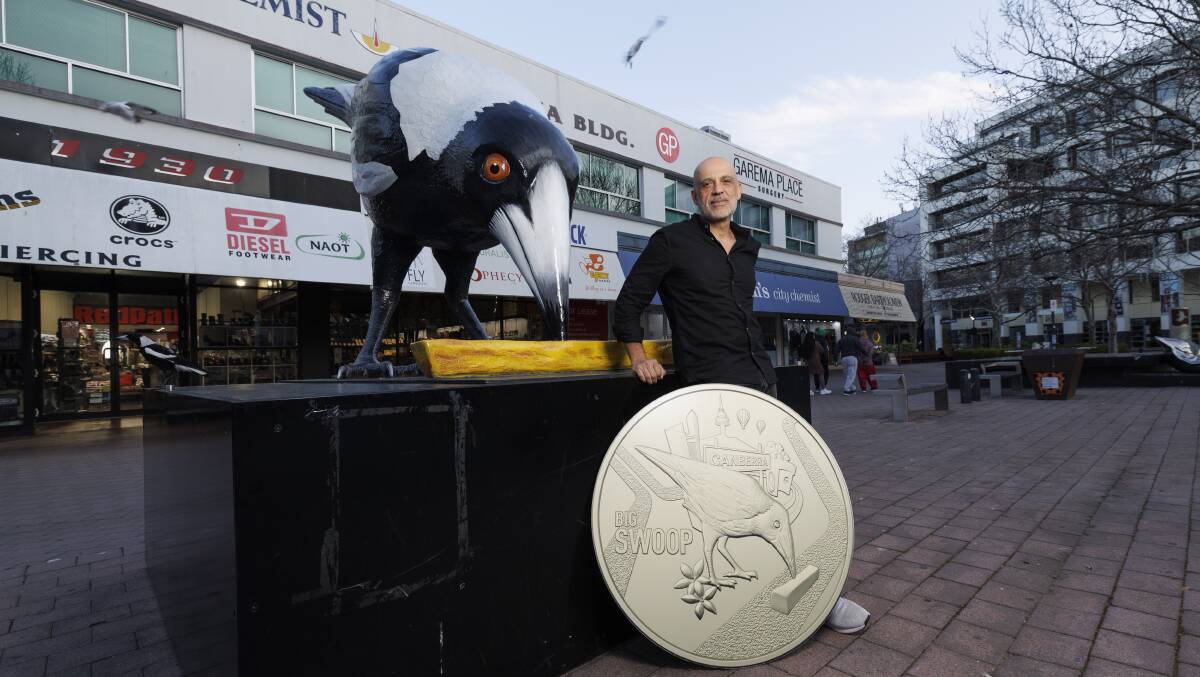 Artist Yanni Pounartzis in Garema Place with a marketing version of the coin in honour of Big Swoop. Picture by Keegan Carroll
