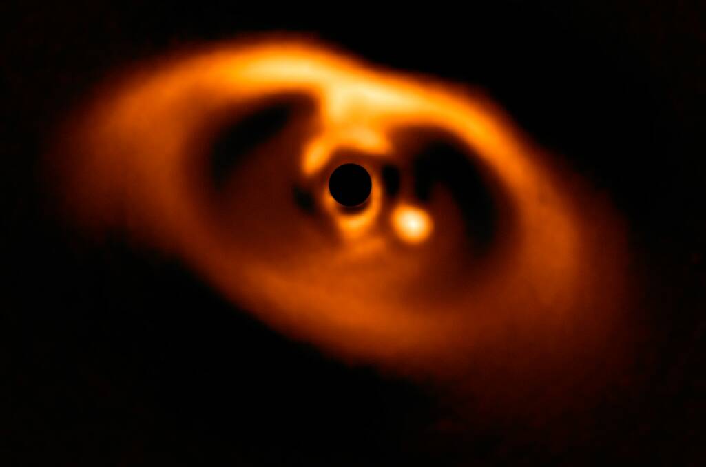 
Image from the SPHERE instrument on ESO's Very Large Telescope of a planet (the bright dot) in the process of formation. Picture: ESO/A. Mller et al.