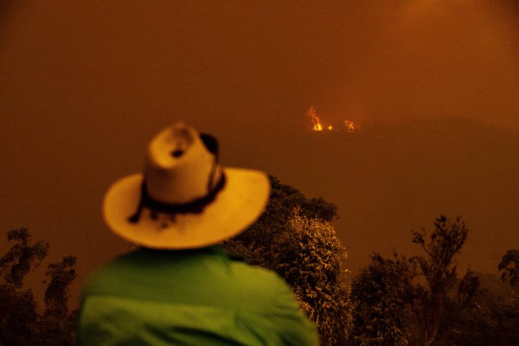 Brett Povey watches as the Clear Range fire approaches his property Glenroy in Colinton. Picture: Sitthixay Ditthavong