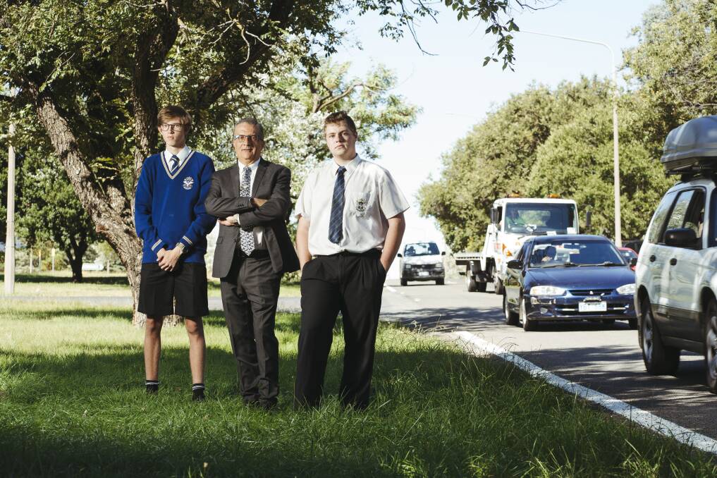 St Edmund's College principal Joe Zavone with students Sebastian Anderson and Jack Thomson beside Canberra Avenue where Mr Zavone wants to see a school zone in place. Picture: Dion Georgopoulos