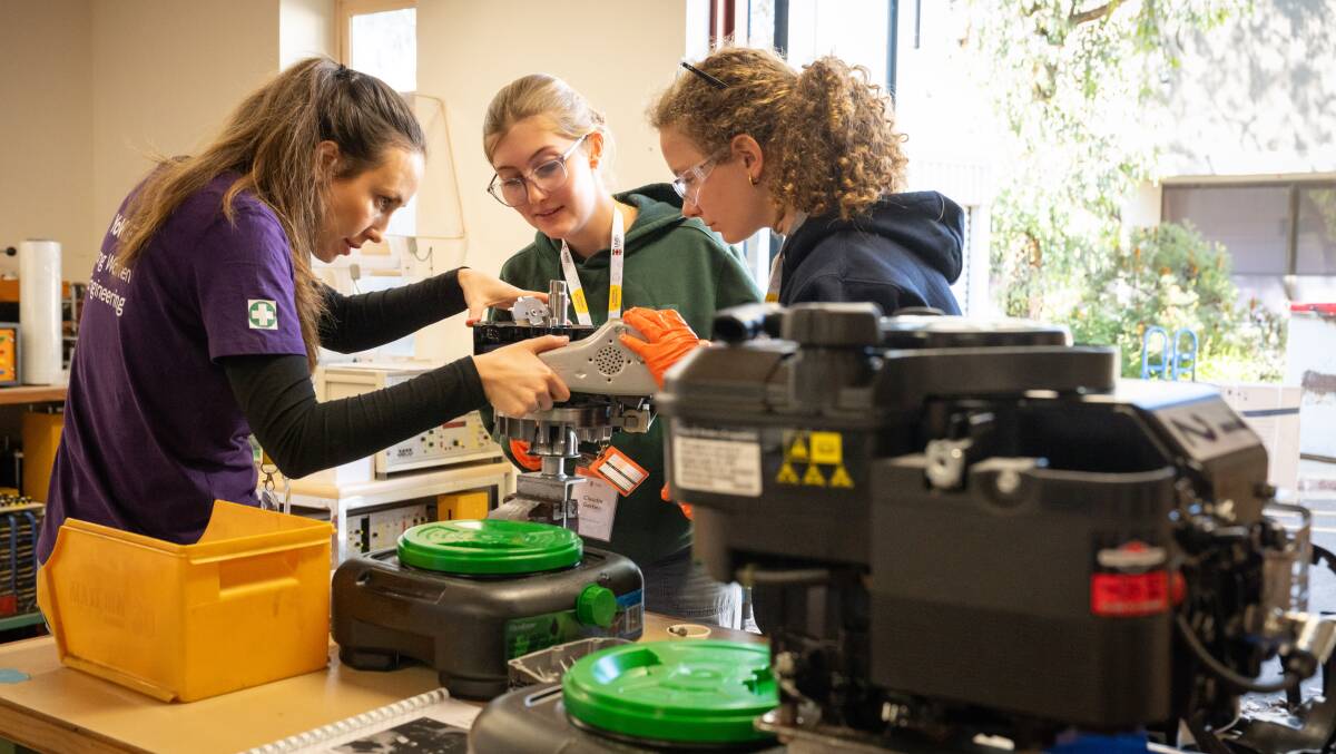 Mechanical engineering lecturer Dr Olga Zinovieva works with high school students from Sydney, Laura Janes and Claudia Gerber, at the YoWIE program offered by UNSW Canberra. Picture by Elesa Kurtz